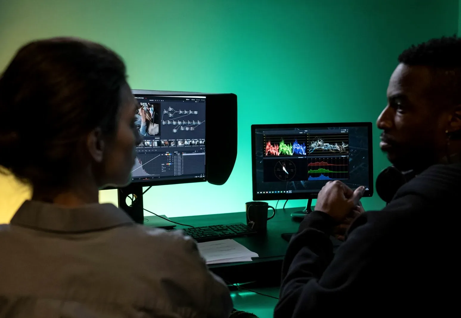 An editor at a colour grading suite with dual monitors